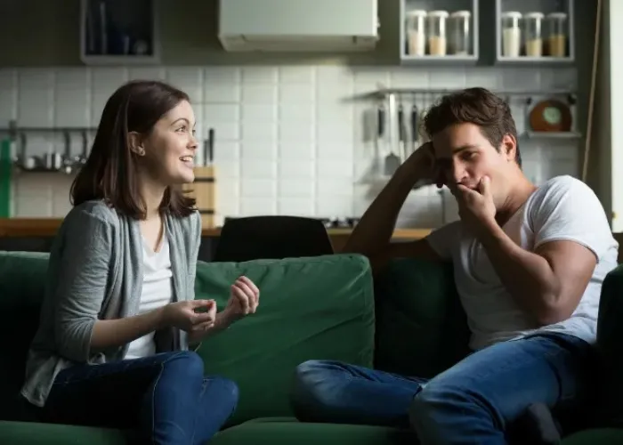 couple having a talk on a couch.